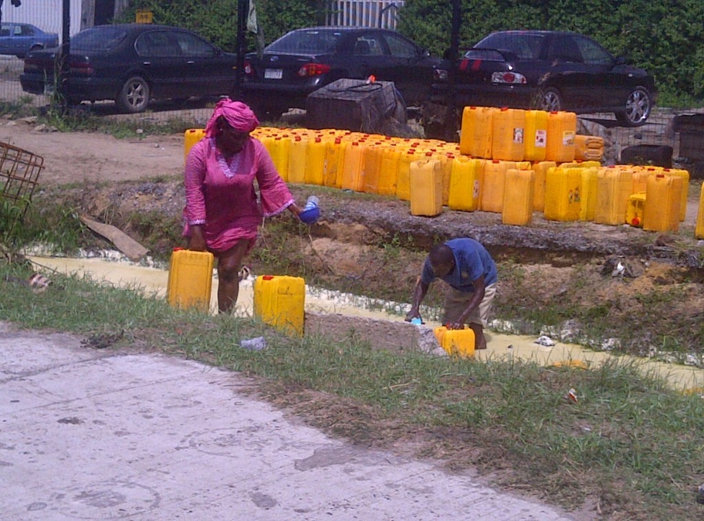 A scene from the accident as jerry cans are lined up to recover some of the vegetable oil